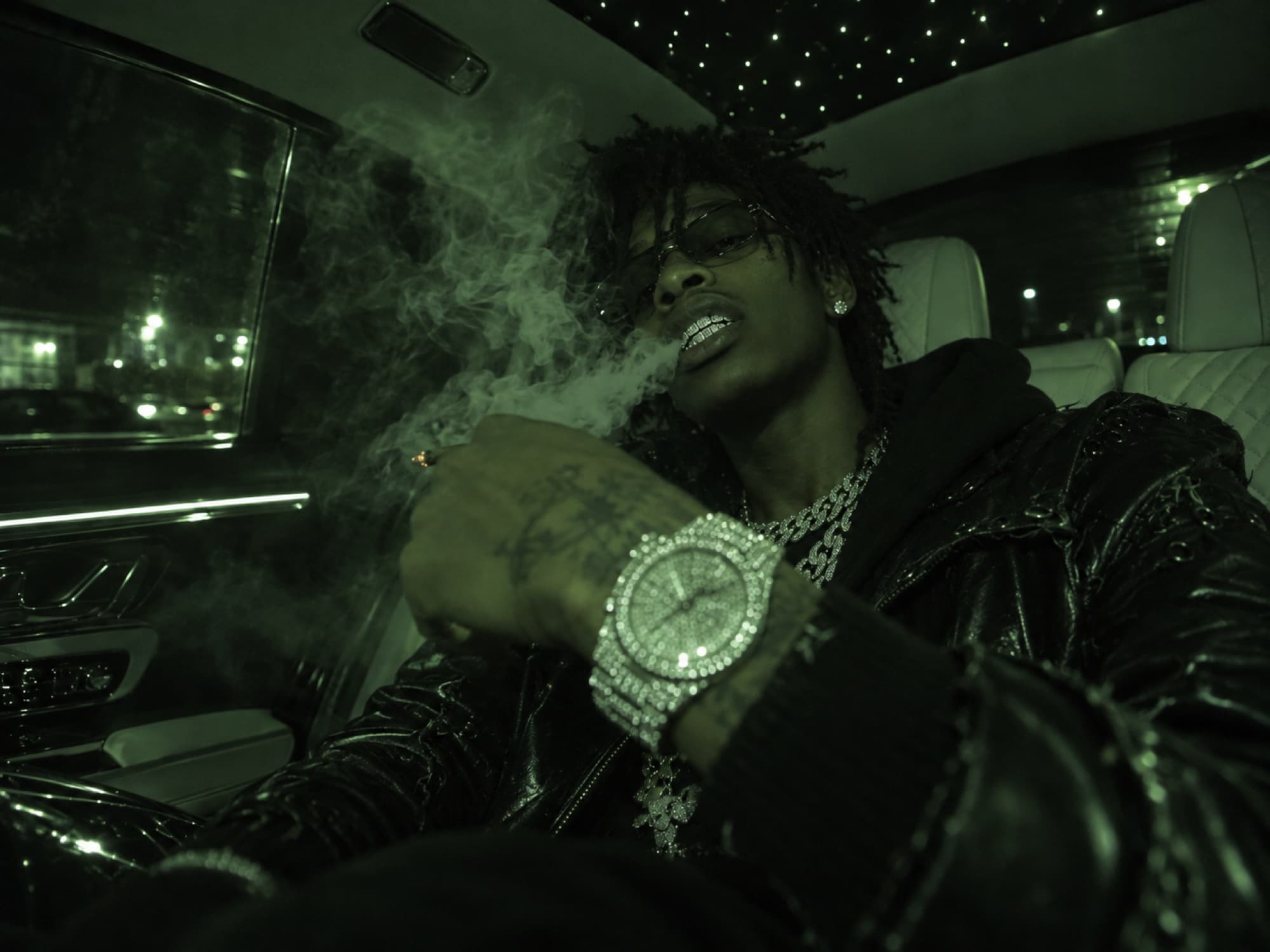 Fully iced-out watch in the back seat of a car